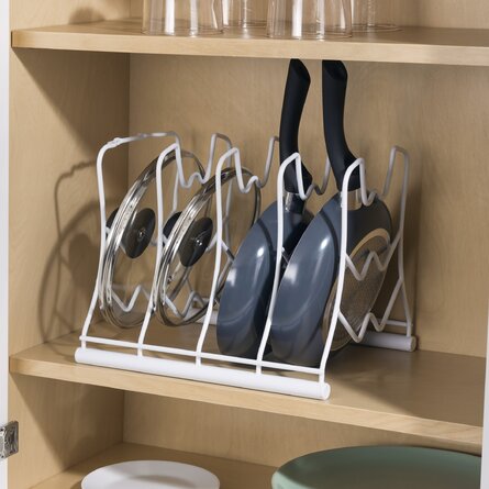 A drainer as storage for cutlery and pot lids